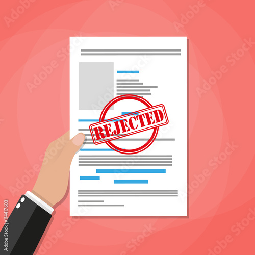 Hand holds rejected paper document