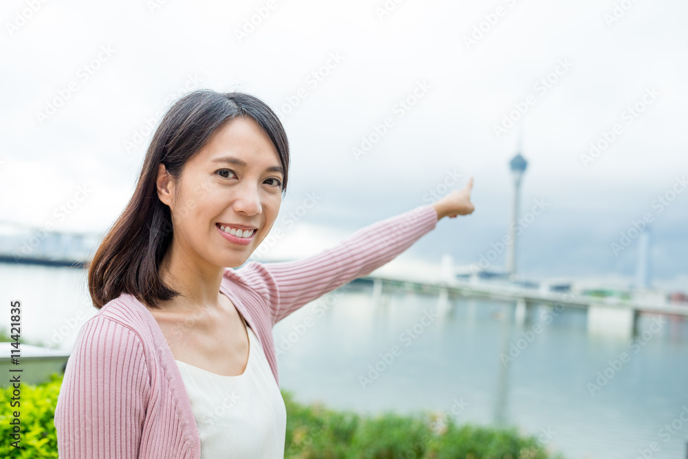Woman pointing the Macau tower
