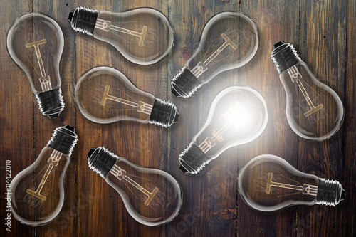 Idea concept - light bulb on the wooden desk