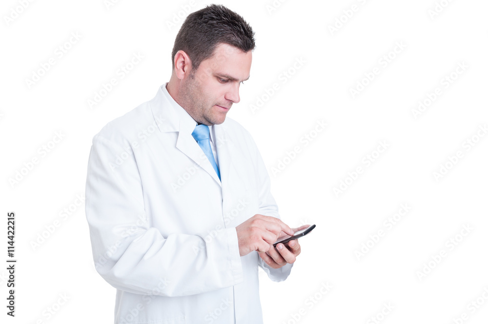 Male doctor or manager texting on his telephone device Male doctor or manager texting on his telephone device