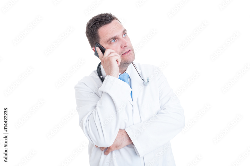 Male doctor speaking at phone offering support or advice Male doctor speaking at phone offering support or advice