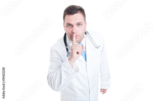 Male medic or doctor making keep quiet gesture