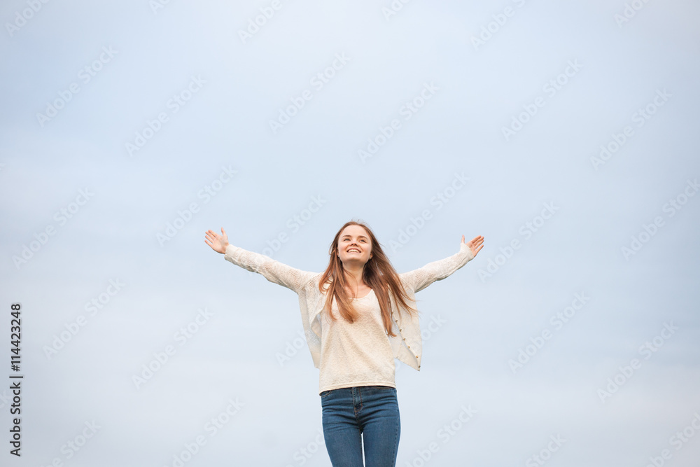 woman with open arms in the sky background at the morning. woman with open arms in the sky background at the morning.