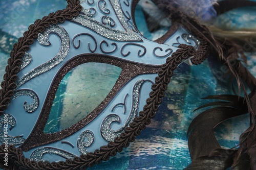 Blue and black female carnival mask on the blue background © Anastasia Pestova