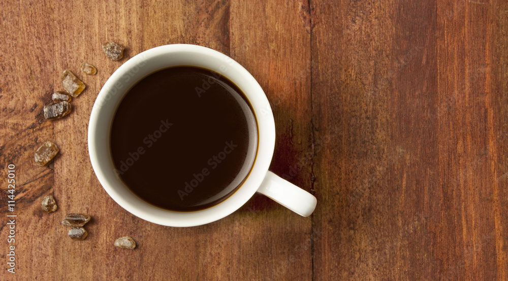 Black coffee in white cup, with cane sugar, with copyspace Black coffee in white cup, with cane sugar, with copyspace