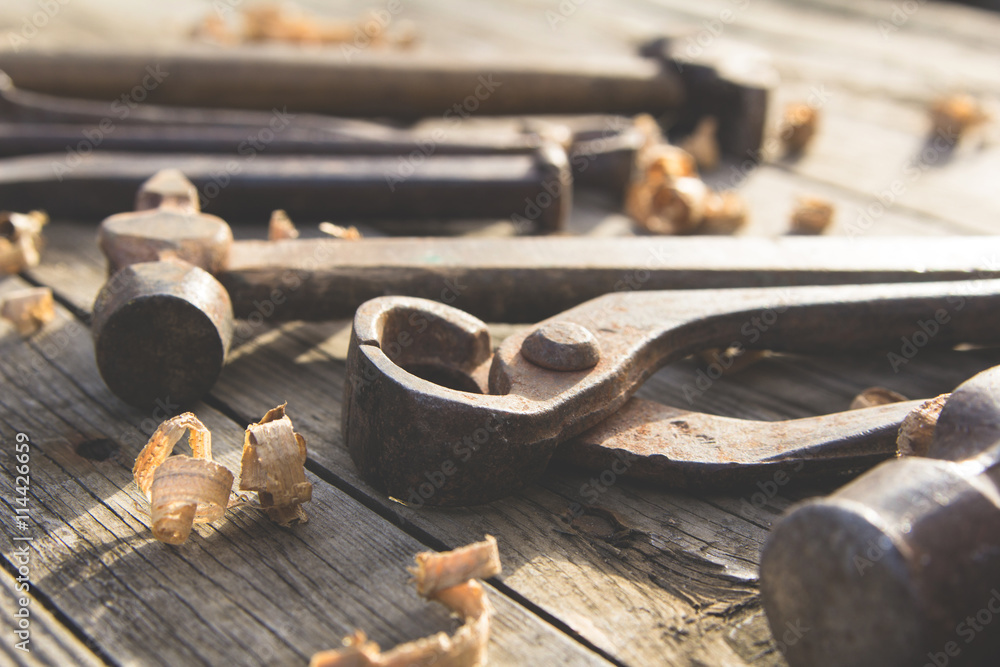 Rusty set of hand tools on a wooden background. Vintage photo Rusty set of hand tools on a wooden background. Vintage photo