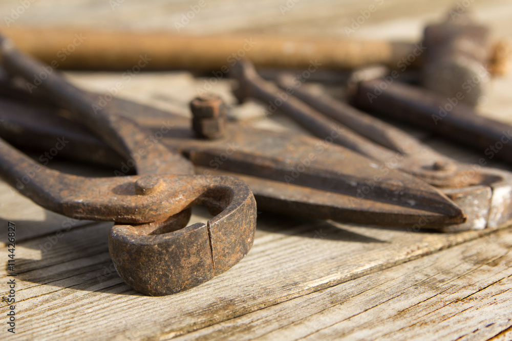 Rusty set of hand tools on a wooden background. Vintage photo Rusty set of hand tools on a wooden background. Vintage photo