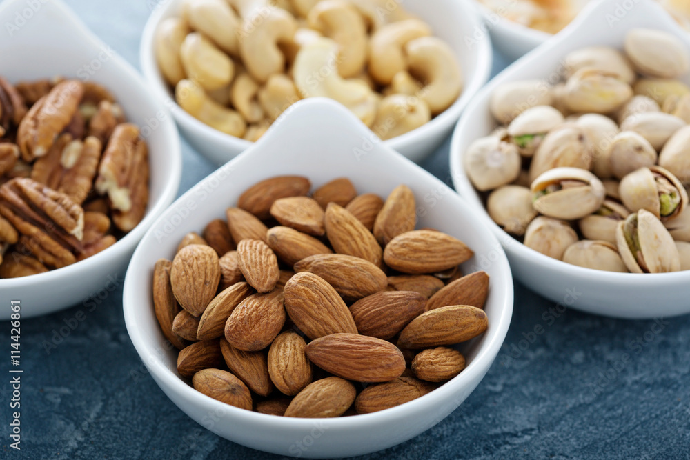 Variety of nuts in small bowls Variety of nuts in small bowls