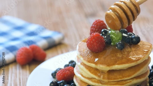 Pancakes with fresh berries, mint and honey