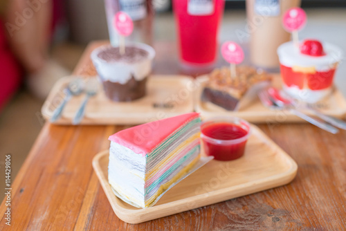 Crepe cake with strawberry sauce on wood table photo