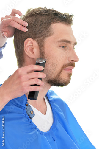 Man having a haircut  from  hairdresser