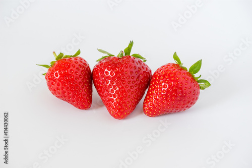 Wallpaper Mural Cluster of ripe red whole fresh strawberries with green stalks and flower buds on a light grey background with Torontodigital.ca