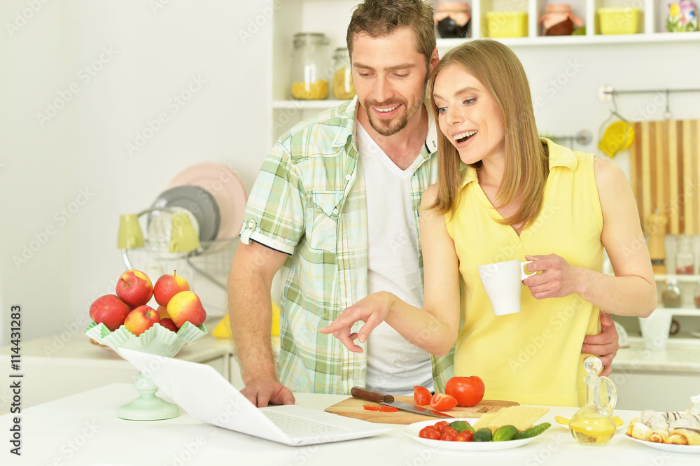 happy couple cooking in kitchen happy couple cooking in kitchen