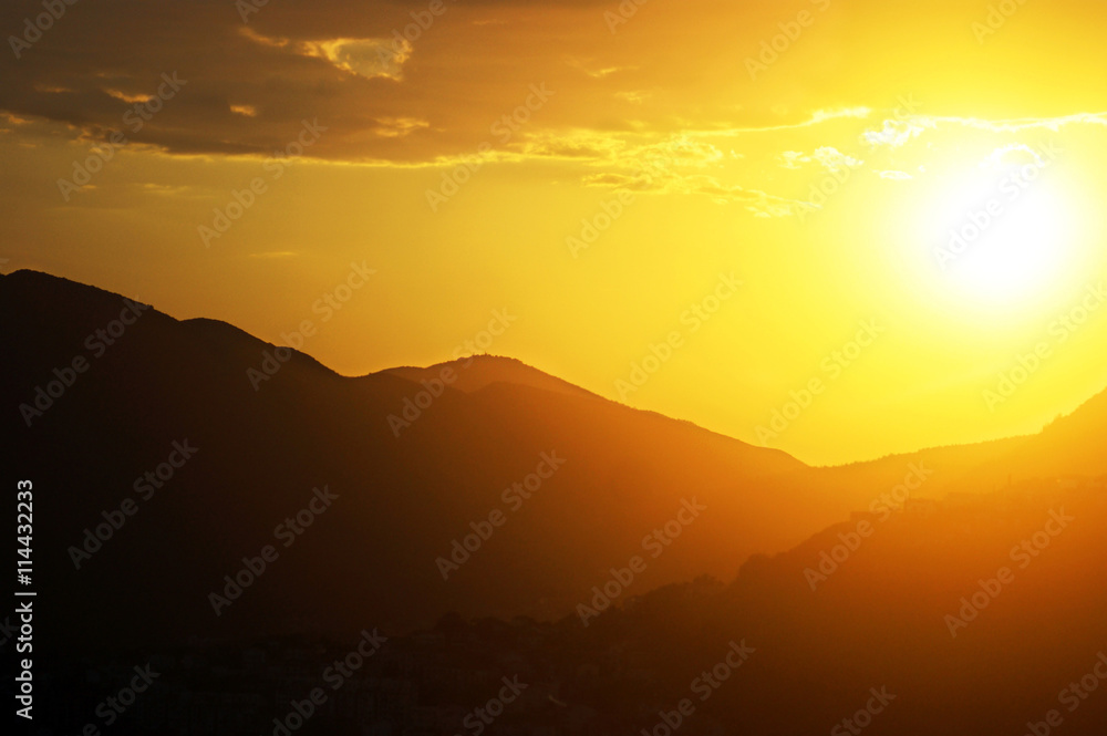 Bright sun over the mountain at sunset Bright sun over the mountain at sunset