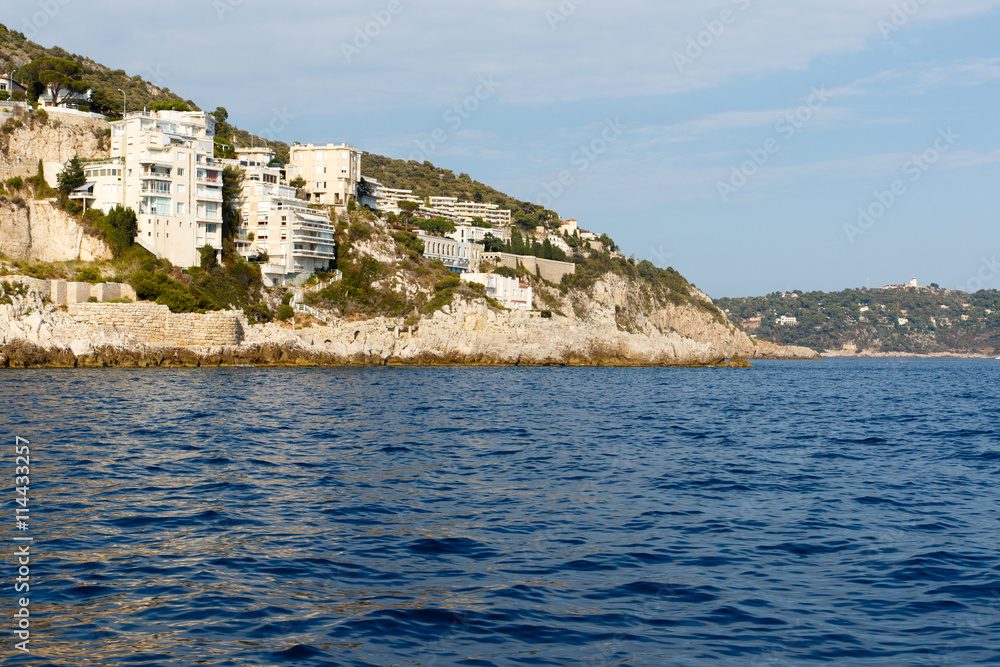Luxury homes on the rocky Mediterranean coast of the French Riviera. Horizontal with copy space for text