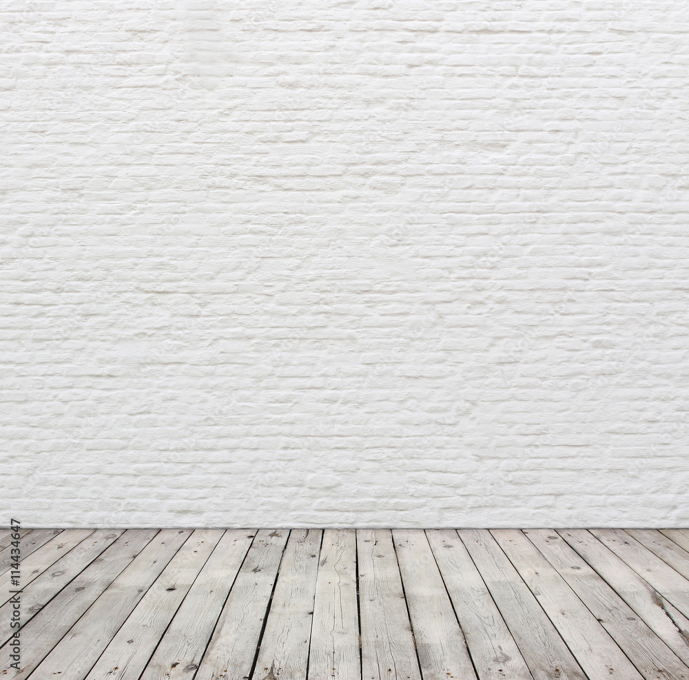 White brick wall and wood floor.