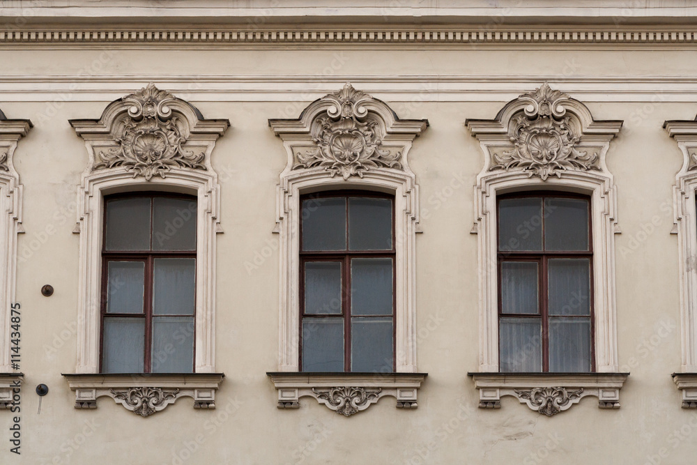 Facade of classical building with row of windows.