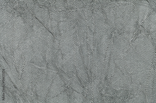 Light gray wavy background from a textile material. Fabric with natural texture closeup.
