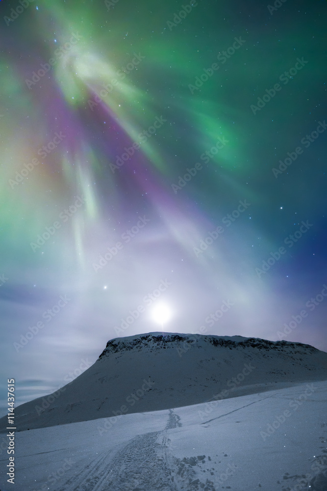 Aurora borealis over mountain, Finland Aurora borealis over mountain, Finland