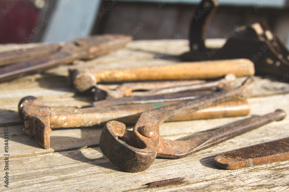 Rusty set of hand tools on a wooden background. Vintage photo Rusty set of hand tools on a wooden background. Vintage photo