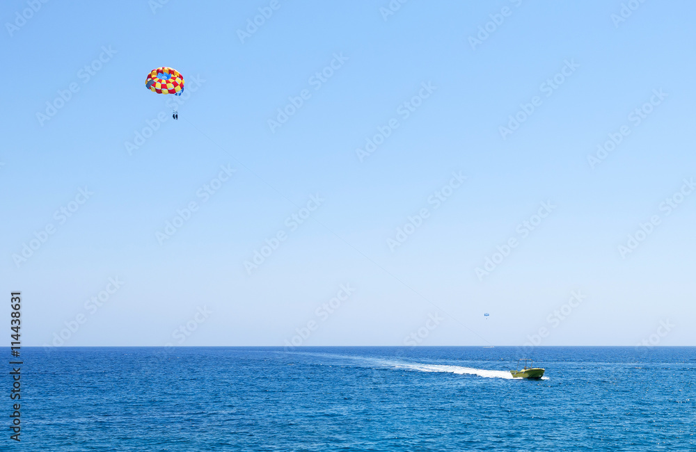 Photo of sea in protaras, cyprus island with parasailing and a boat. Photo of sea in protaras, cyprus island with parasailing and a boat.
