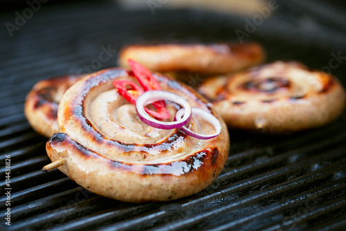 Obraz na plátně cumberland sausage, spiral pork sausage on bbq grill with no fla