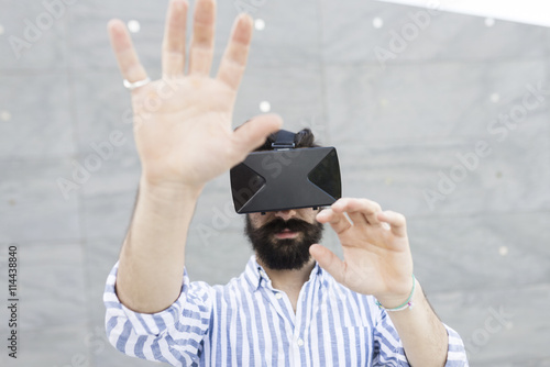 Man playing with Virtual Reality Glasses photo
