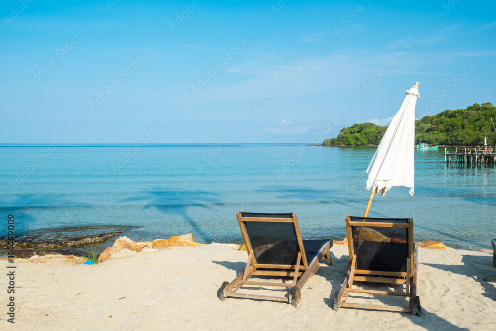 Beach bed with umbrella on white sand beach Beach bed with umbrella on white sand beach