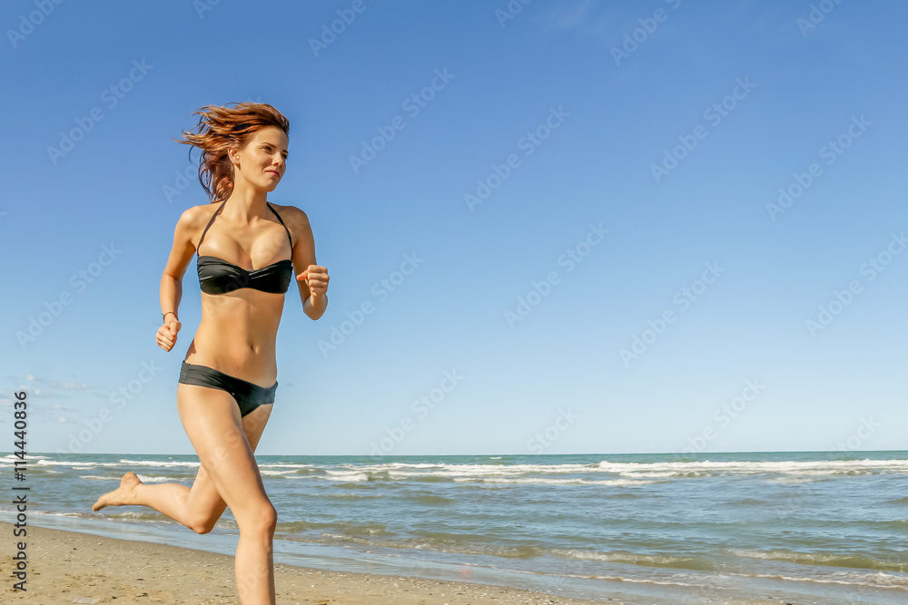 Fototapeta premium natural beauty doing fitness and jogging on beach
