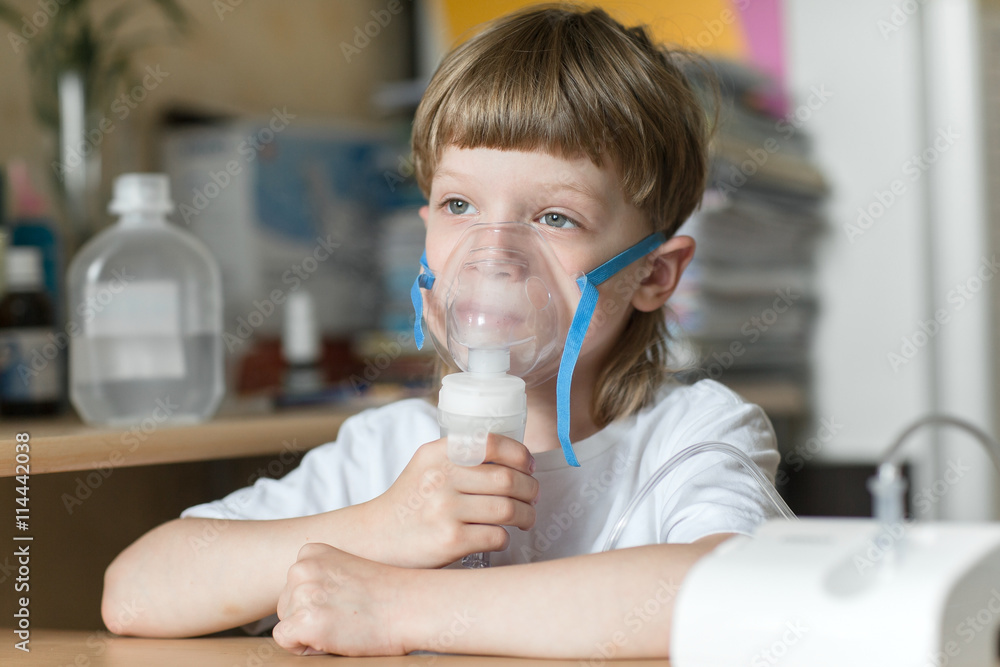 child holds a mask vapor inhaler