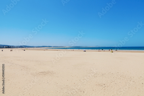 Clear blue sky over emerald sea and yellow sandy beach  Agadir  Morocco