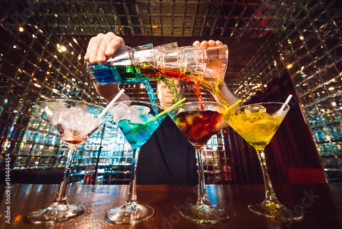 Barman show. Bartender pours alcoholic cocktails. photo