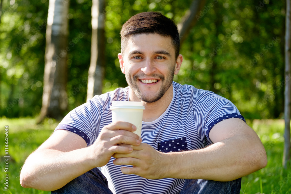 Man with coffee in park Man with coffee in park