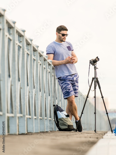 Man with camera on tripod