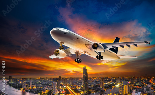 Airplane over night scene city