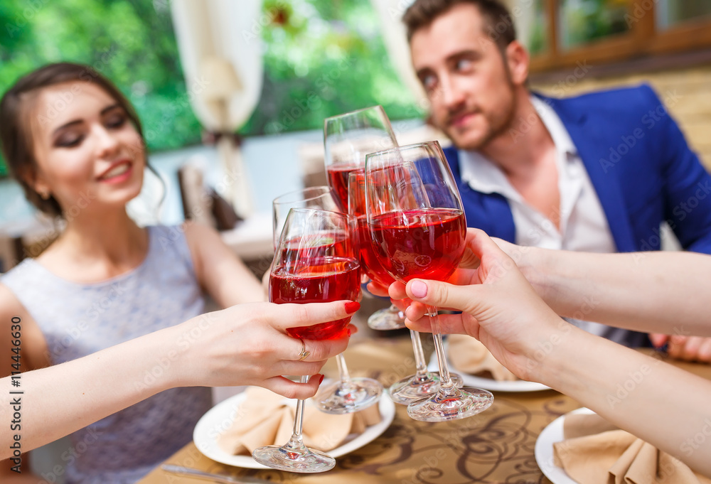 Friends drinking wine on the summer terrace. Friends drinking wine on the summer terrace.