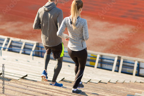 couple running downstairs on stadium photo