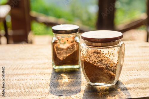 Brown sugar in bottle on wood table