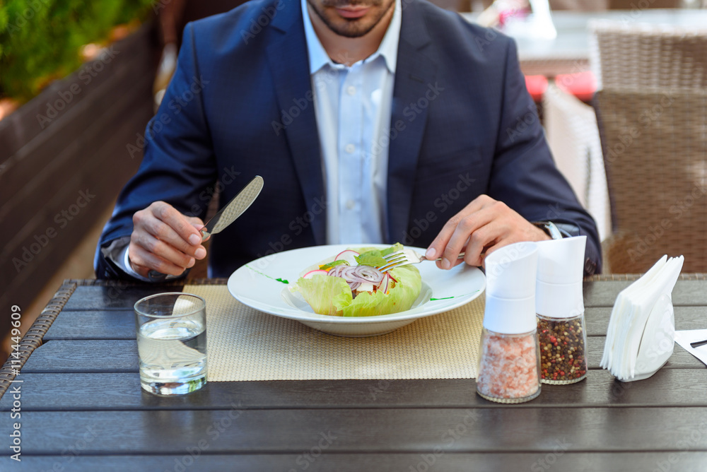 Business man having breakfast in cafe