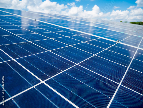 Solar panels with blue sky and clouds