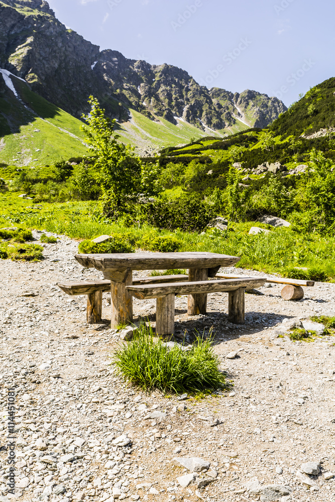 Bench and table on a trail in the mountains.