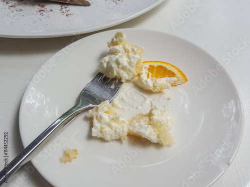 remains dish of whipping cream from orange cake, selective focus