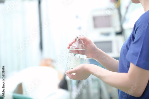 Nurse holding solution bottle in hands