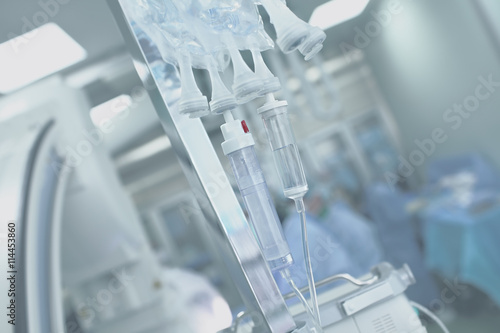 Medical IV drip systems on a background of the operating room photo