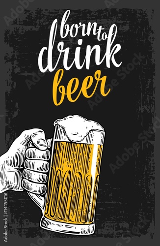 Male hand holding a beer glass.