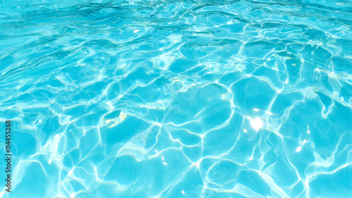 Beautiful water surface in swimming pool with sun reflection