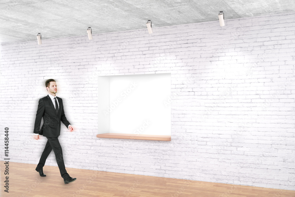 Man walking past built-in-wall seating