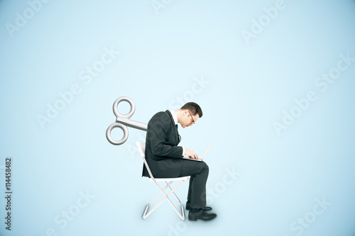 Businessperson with wind-up key