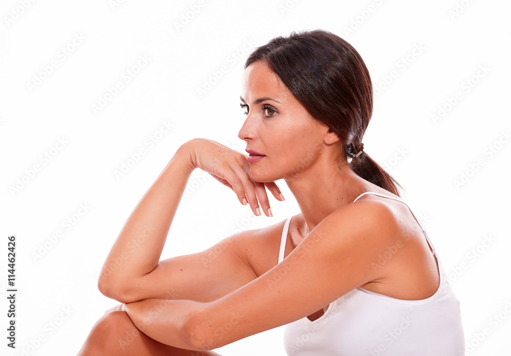 Fototapeta premium Attractive thoughtful brunette young woman sitting