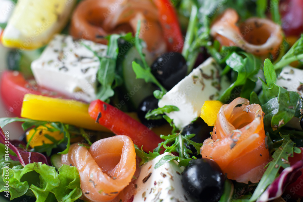 Salmon salad with brie and olives closeup. Smoked salmon, brie, olives, lettuce and pepper mix with herbs. Mediterranean tasty snack background Salmon salad with brie and olives closeup. Smoked salmon, brie, olives, lettuce and pepper mix with herbs. Mediterranean tasty snack background